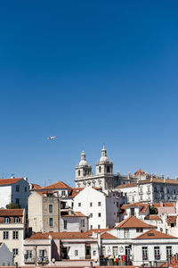 Buildings in city against blue sky