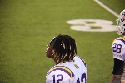 Rear view of woman standing on field