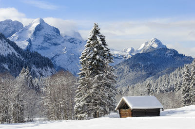 Scenic view of snow covered mountains against sky