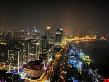 High angle view of illuminated city buildings at night