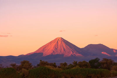 Scenic view of mountains against orange sky