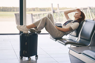 Rear view of woman sitting on table