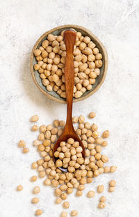 Directly above shot of eggs in container against white background