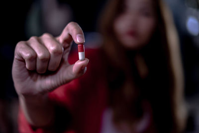 Close-up of woman hand holding red text