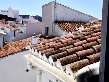 Roof of building against cloudy sky