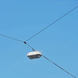 Low angle view of overhead cable against clear sky