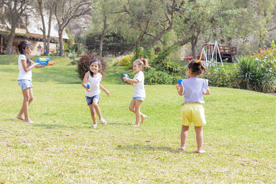 Siblings playing in lawn