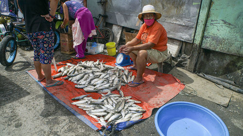 People working at market stall