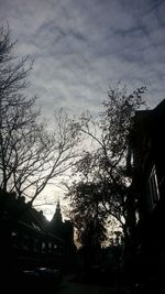 Silhouette trees against sky at dusk