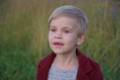 Portrait of cute boy standing outdoors