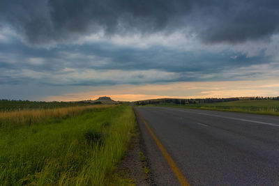 Scenic view of agricultural field against dramatic sky