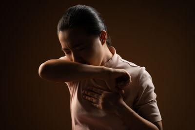 Portrait of a girl looking away over black background