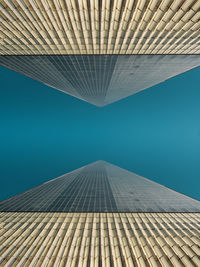 Low angle view of modern building against blue sky