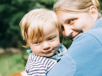 Portrait of cute mother with son outdoors