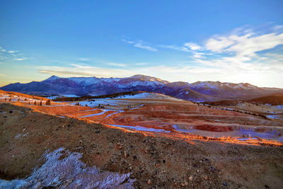 Scenic view of landscape and mountains against blue sky