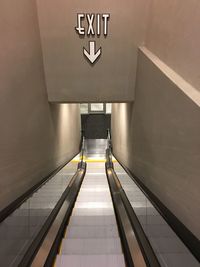 Exit sign over escalator