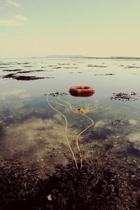 Boat floating on water against sky