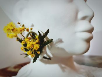 Close-up of woman holding flower