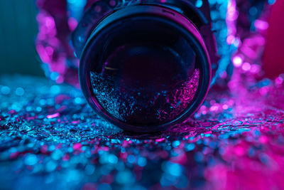 Close-up of lens in neon light