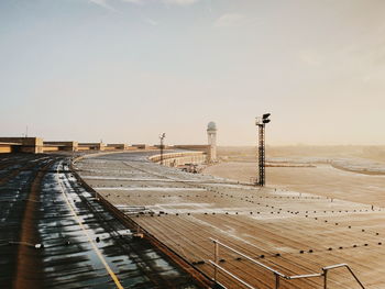 View of airport runway against sky during sunset