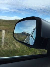 Reflection of car on side-view mirror