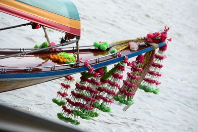 Cropped image of boat with flower decoration in lake