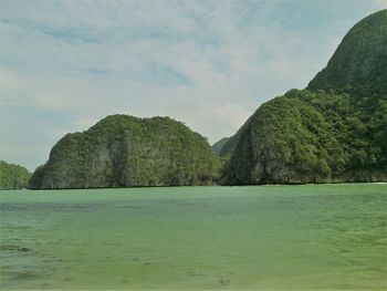 Scenic view of sea and mountains against sky