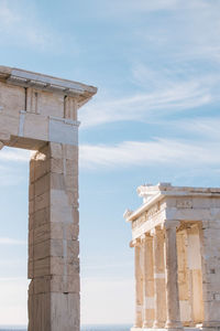 Low angle view of acropolis against sky during sunny day