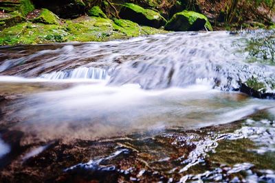 Scenic view of stream flowing through rocks