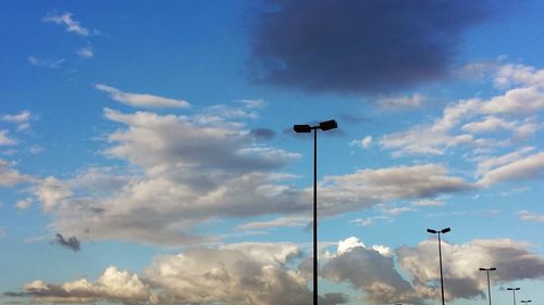 Low angle view of street light against cloudy sky