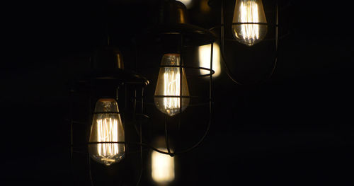 Close-up of illuminated light bulb in darkroom