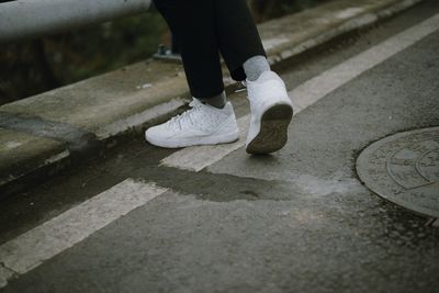 Low section of man standing on footpath