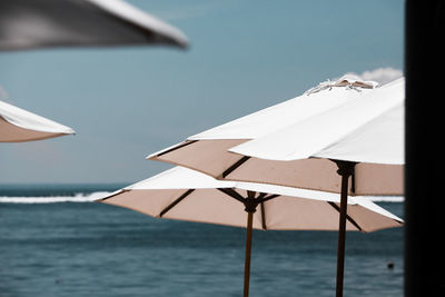 Umbrellas on beach against sky