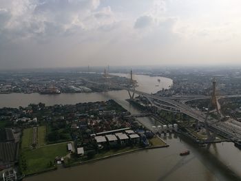 High angle view of cityscape by sea against sky