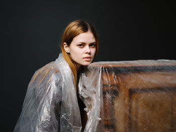 Portrait of woman leaning on piano