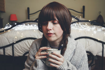 Portrait of young woman drinking drink