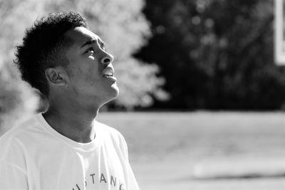 Teenage boy looking up on field