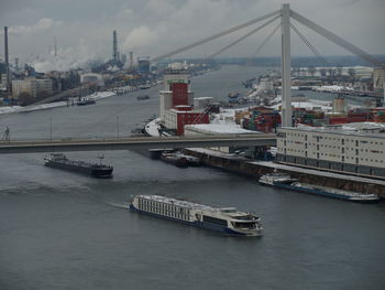 Nautical vessel on river against sky in city