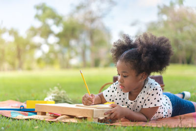 Portrait of girl holding pencils