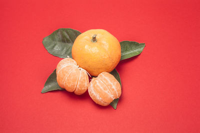 Close-up of oranges against red background