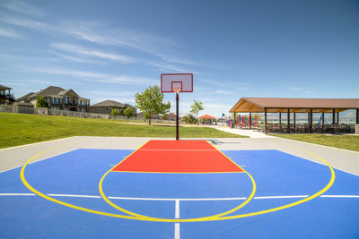 View of basketball court against blue sky