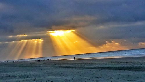 Scenic view of beach against sky during sunset