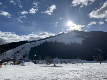 Scenic view of snow covered mountains against sky