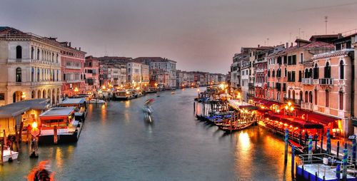 High angle view of boats on canal in illuminated city