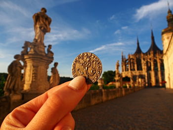 Low angle view of man holding statue