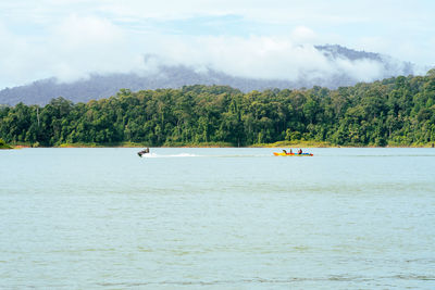 People enjoying water activities on banana boat at the kenyir lake, terengganu, malaysia.