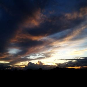 Silhouette of mountain against dramatic sky