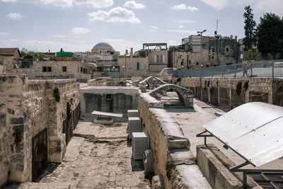 View of old buildings against cloudy sky