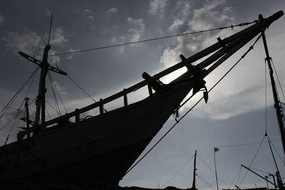 Low angle view of silhouette sailboat against sky during sunset