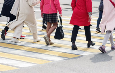 Low section of people walking on road